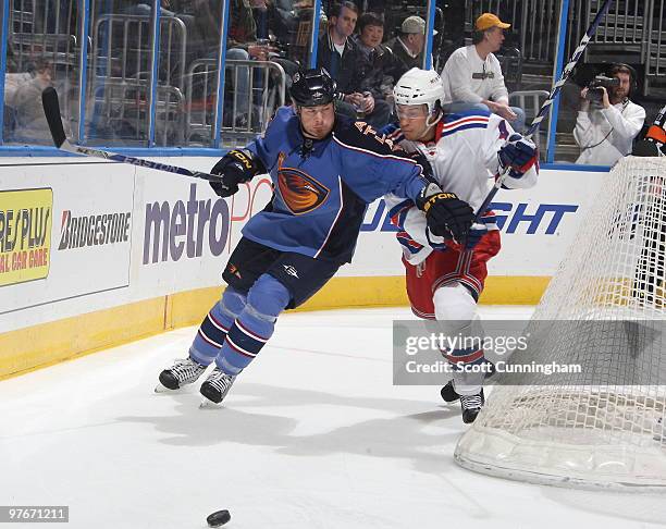 Eric Boulton of the Atlanta Thrashers battles for the puck against Michael Del Zotto of the New York Rangers at Philips Arena on March 12, 2010 in...