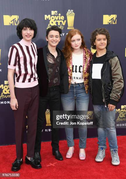 Actors Finn Wolfhard, Noah Schnapp, Sadie Sink, and Gaten Matarazzo attend the 2018 MTV Movie And TV Awards at Barker Hangar on June 16, 2018 in...