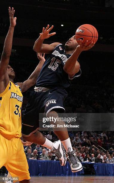 Austin Freeman of the Georgetown Hoyas goes up with the ball against Jimmy Butler the Marquette Golden Eagles during the semifinal of the 2010 Big...