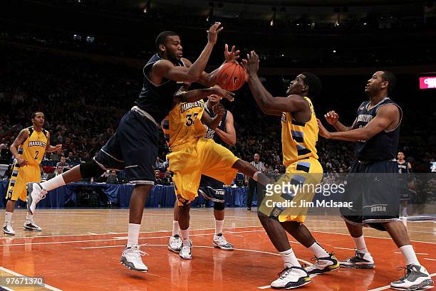 Greg Monroe of the Georgetown Hoyas goes for a loose ball against Jimmy Butler and Darius Johnson-Odom of the Marquette Golden Eagles during the...