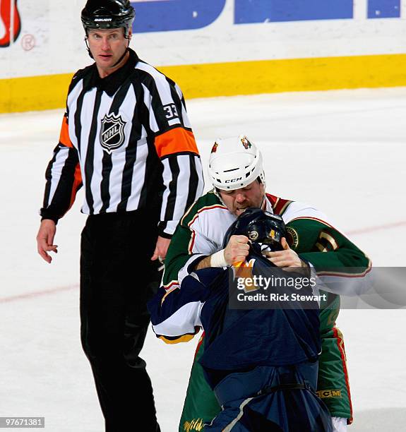 Owen Nolan of the Minnesota Wild and Steve Montador of the Buffalo Sabres fight as referee Kevin Pollock looks on at HSBC Arena on March 12, 2010 in...