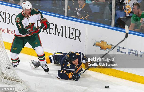 Raffe Torres of the Buffalo Sabres hits the ice after being checked by Marek Zidlicky of the Minnesota Wild at HSBC Arena on March 12, 2010 in...