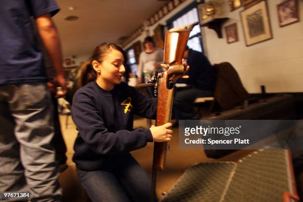 Student puts her rifle away following a competition at the 79th Anniversary Gallery Match for area high school students at the Blue Trail Range on...