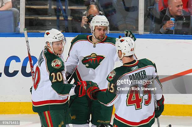 Antti Miettinen, Guillaume Latendresse and Cam Barker of the Minnesota Wild celebrate Latendresse's goal in the first period against the Buffalo...