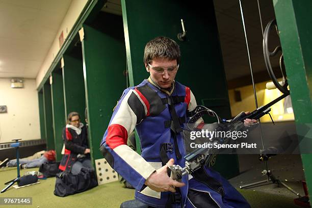 Nick Sautter checks his gun during competition at the 79th Anniversary Gallery Match for area high school students at the Blue Trail Range on March...