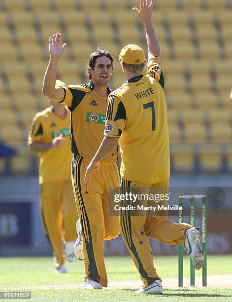 Mitchell Johnson and Cameron White of Australia celebrate Shanan Stewart of the Blackcaps being caught out during the 5th ODI at Westpac Stadium on...