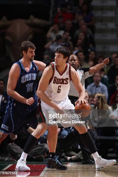 Andrew Bogut of the Milwaukee Bucks posts up against Mehmet Okur of the Utah Jazz on March 12, 2010 at the Bradley Center in Milwaukee, Wisconsin....