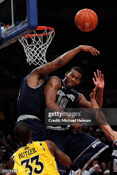 Greg Monroe of the Georgetown Hoyas blocks the shot of Jimmy Butler of the Marquette Golden Eagles during the semifinal of the 2010 Big East...