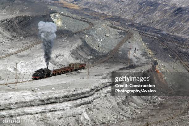 Against a wall of outcropping coal a Chinese SY 2-8-2 works in the huge opencast pit at Pingzhuang in October 2006.