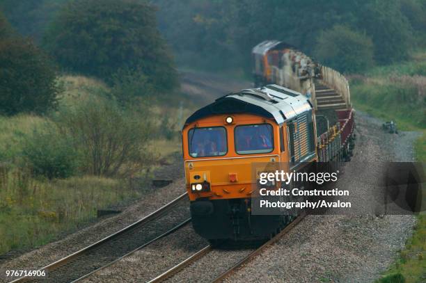 An engineer's train topped and tailed by GBRf class 66 diesel electrics pass through Kibworth on the Midland Main Line on Friday 10th September 2004,...