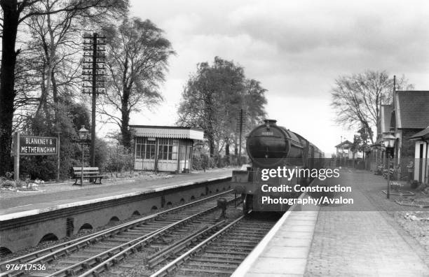 Blankney and Metheringham station on the GN&GE Joint Railway line between Spalding and Lincoln with an approaching Gresley V2 No 60858 with a two...