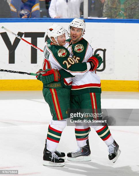 Antti Miettinen and Andrew Brunette of the Minnesota Wild celebrate Brunette's goal in the second period against the Buffalo Sabres at HSBC Arena on...