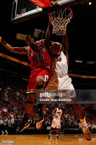 Joel Anthony of the Miami Heat shoots against James Johnson of the Chicago Bulls on March 12, 2010 at American Airlines Arena in Miami, Florida. NOTE...