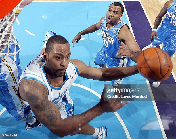 Morris Peterson of the New Orleans Hornets shoots over Malik Allen of the Denver Nuggets on March 12, 2010 at the New Orleans Arena in New Orleans,...