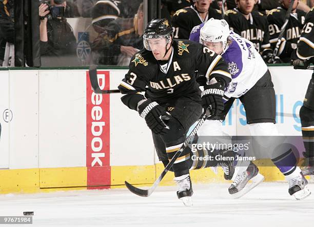 Stephane Robidas of the Dallas Stars skates against Fredrik Modin of the Los Angeles Kings on March 12, 2010 at the American Airlines Center in...
