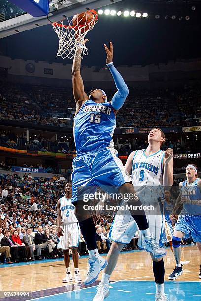 Carmelo Anthony of the Denver Nuggets shoots over Darius Songaila of the New Orleans Hornets on March 12, 2010 at the New Orleans Arena in New...