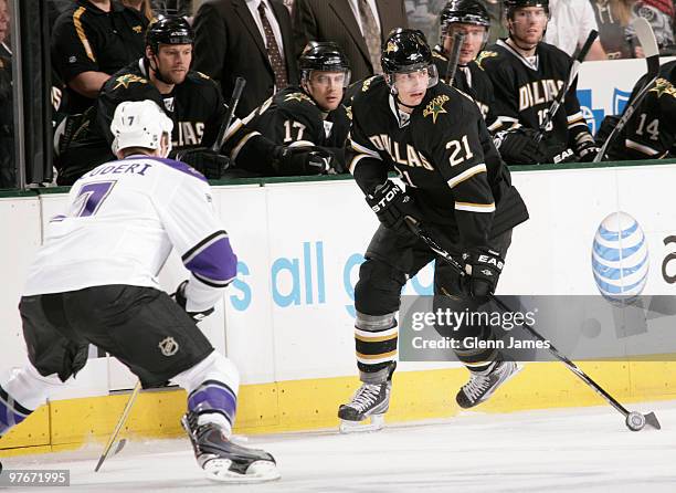 Loui Eriksson of the Dallas Stars skates against Rob Scuderi of the Los Angeles Kings on March 12, 2010 at the American Airlines Center in Dallas,...