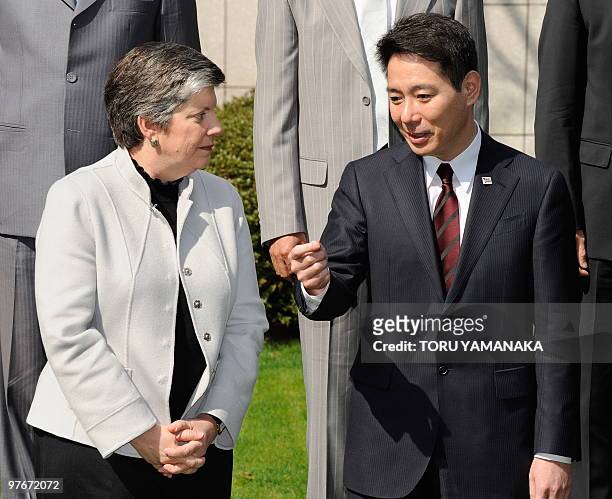 Japan's Land, Infrastructure, Transport and Tourism Minister Seiji Maehara chats with US Homeland Security Secretary Janet Napolitano during the...