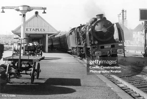 French Railways SNCF Class 231E stands with a passenger train, circa 1956.