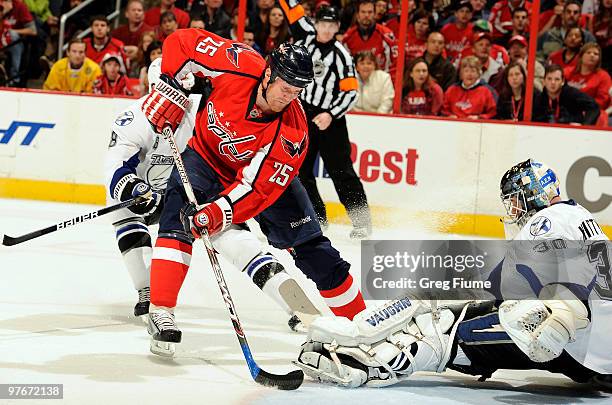 Antero Nittymaki of the Tampa Bay Lightning makes a save against Jason Chimera of the Washington Capitals on March 12, 2010 at the Verizon Center in...