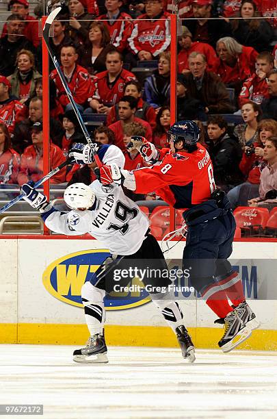 Alex Ovechkin of the Washington Capitals collides with Stephane Veilleux of the Tampa Bay Lightning on March 12, 2010 at the Verizon Center in...