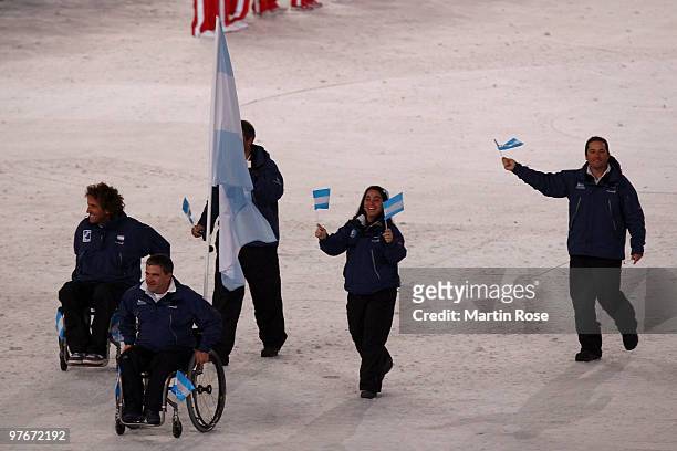 Flag bearer Juan Ignacio Maggi of Argentina leads his team through the stadium during the Opening Ceremony of the 2010 Vancouver Winter Paralympic...