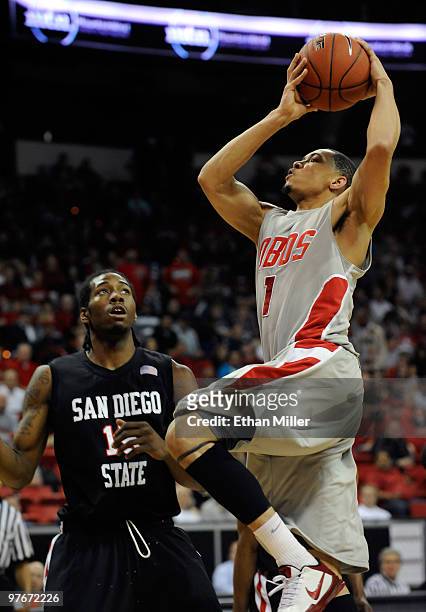 Darington Hobson of the New Mexico Lobos goes up for a shot against Kawhi Leonard of the San Diego State Aztecs during a semifinal game of the Conoco...