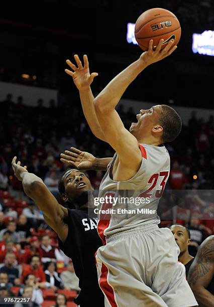 Phillip McDonald of the New Mexico Lobos goes up for a shot against Kawhi Leonard of the San Diego State Aztecs during a semifinal game of the Conoco...