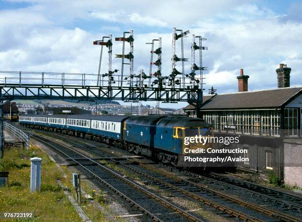 Inverness. No 47018 heads south past Welsh's Bridge Box with the 12.32 service for Aberdeen. 10th August 1985, United Kingdom.