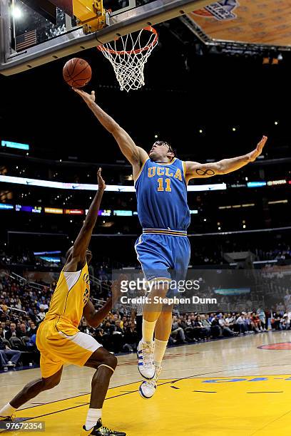 Reeves Nelson of the UCLA Bruins shoots over Patrick Christopher of the California Golden Bears during the semifinals of the Pac-10 Basketball...