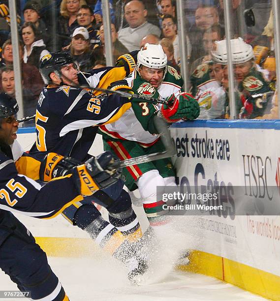 Jochen Hecht of the Buffalo Sabres checks Marek Zidlicky of the Minnesota Wild on March 12, 2010 at HSBC Arena in Buffalo, New York.