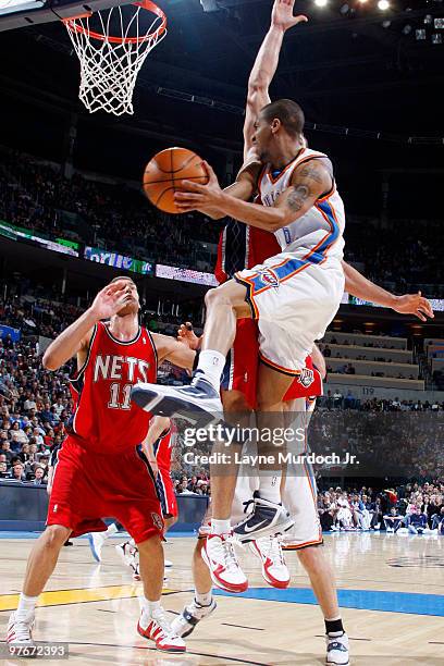 Eric Maynor of the Oklahoma City Thunder passes the ball around Kris Humphries and Brook Lopez of the New Jersey Nets on March 12, 2010 at the Ford...