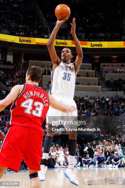 Kevin Durant of the Oklahoma City Thunder shoots over Kris Humphries of the New Jersey Nets on March 12, 2010 at the Ford Center in Oklahoma City,...