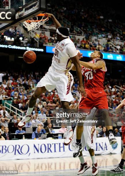 Chris Singleton of the Florida State Seminoles dunks in front of Johnny Thomas of the North Carolina State Wolfpack in their quarterfinal game in the...