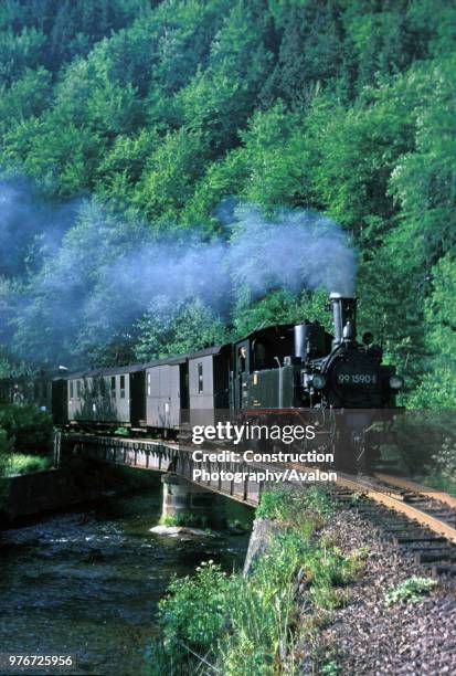 Meter gauge German Mallet 0-4-4-0T No 99.1590 leads along the Wolkenstein- Johstadt Line with the 16.49 passenger train to Niederschmiedeberg on a...