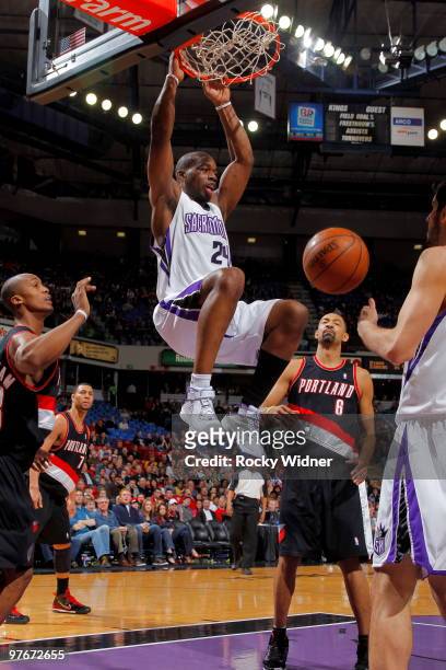 Carl Landry of the Sacramento Kings dunks the ball in front of Juwan Howard of the Portland Trail Blazers on March 12, 2010 at ARCO Arena in...