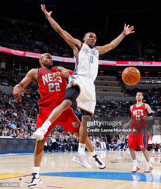 Russell Westbrook of the Oklahoma City Thunder is fouled by Jarvis Hayes of the New Jersey Nets on March 12, 2010 at the Ford Center in Oklahoma...