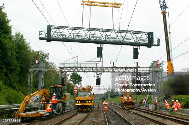 New signal gantry being craned into position at Berkhamsted from a roadside mounted crane during the upgrading of the West Coast Main Line. Saturday...