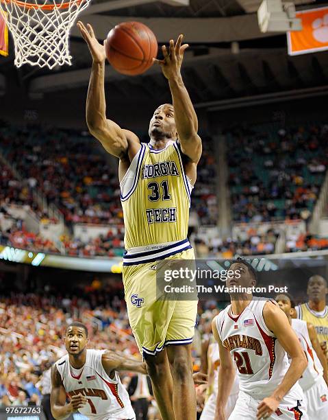 Tech's Gani Lawal gather in a rebound over Maryland's Greivis Vasquez as Georgia Tech defeats the University of Maryland 69 - 64 in the quarter...