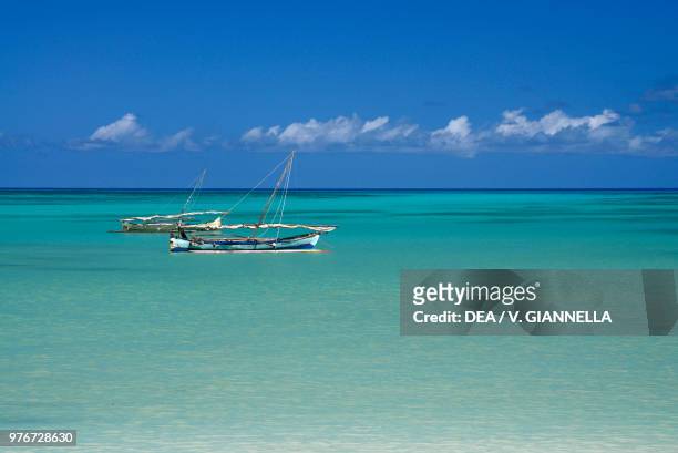 Fishing boats moored off the beach, Nosy Be island, Madagascar.