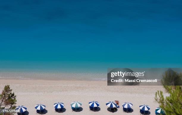 the parasols at egremni; lefkadha, ionian islands - egremni stock pictures, royalty-free photos & images