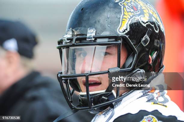 Johnny Manziel of the Hamilton Tiger-Cats stands on the sidelines during a CFL game against the Calgary Stampeders at McMahon Stadium on June 16,...