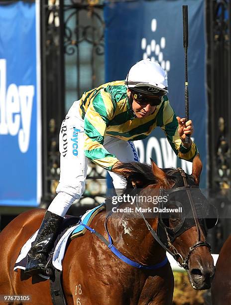 Jockey Michael Rodd riding Rock Classic salutes as he wins Race 7 the Crown Guineas during the Super Family Day meeting at Flemington Racecourse on...