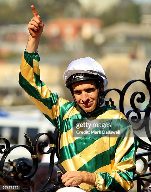 Jockey Michael Rodd riding Rock Classic salutes as he returns to scale after winning Race 7 the Crown Guineas during the Super Family Day meeting at...