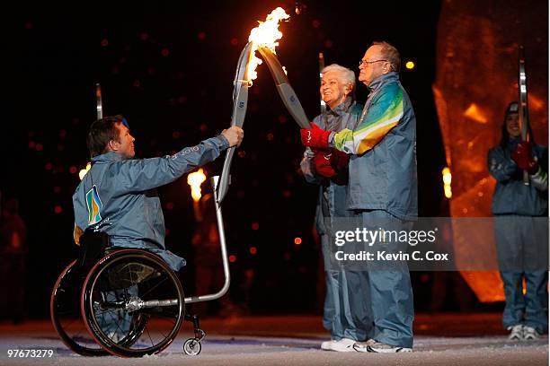 Betty and Rolly Fox , parents of Terry Fox, light Daniel Wesley's torch during the Opening Ceremony of the 2010 Vancouver Winter Paralympic Games at...