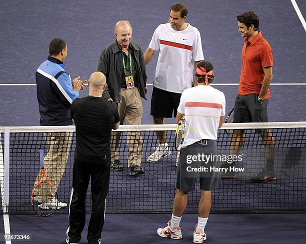 Rod Laver of Australia comes to center court to toss out the coin before the match between Pete Sampras of the United States and Roger Federer of...