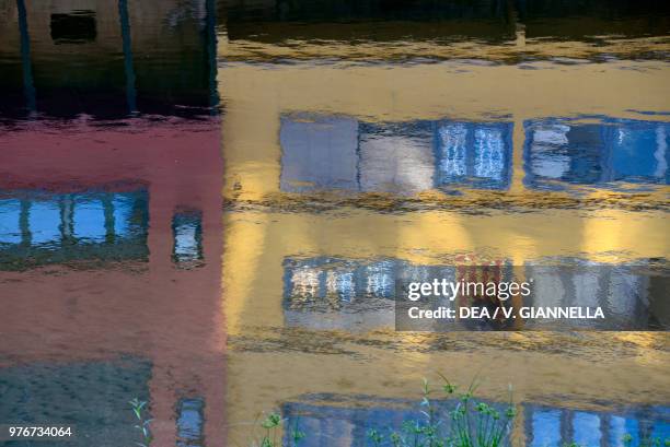 Homes reflected in the water of the Onyar River, Girona, Spain.