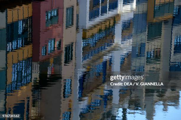 Homes reflected in the water of the Onyar River, Girona, Spain.