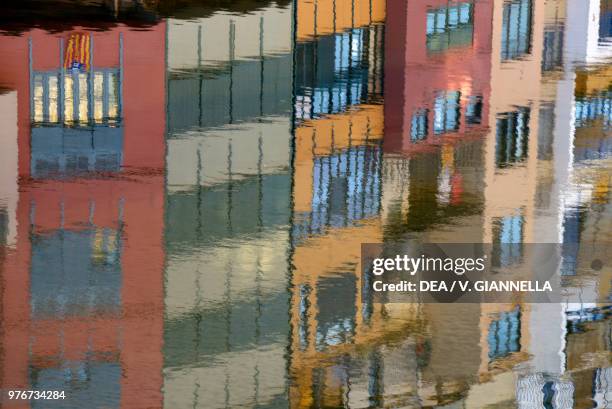 Homes reflected on the waters of the Onyar River, Girona, Spain.
