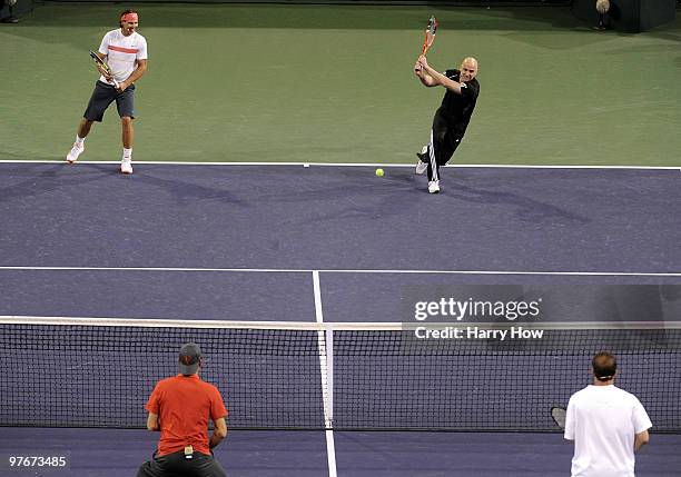 Andre Agassi of the United States and Rafael Nadal of Spain return serve against Pete Sampras of the United States and Roger Federer of Switzerland...